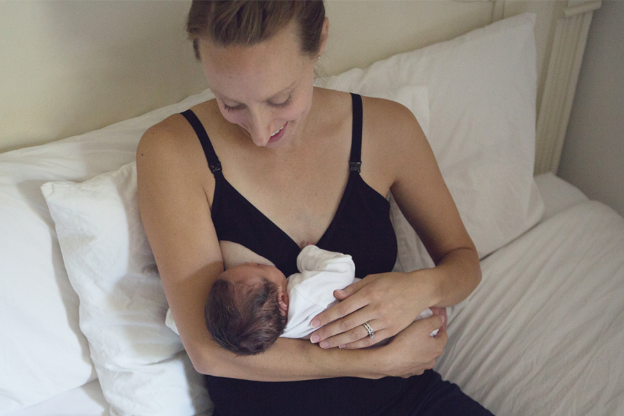 Mother breastfeeding newborn in Boob Design merino singlet
